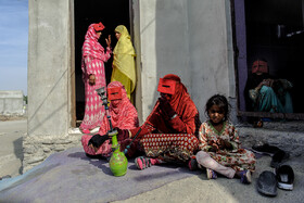 کلثوم ساربانی فرد، ۵۰ ساله، در حال قلیان کشیدن و وقت گذرانی با سایر زنان روستای جیفری است.