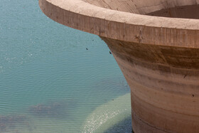 دهانه نیلوفری سد 15 خرداد قم که باید کاملا درون آب باشد ولی به دلیل کاهش آب ورودی به پشت سد این دریچه کاملا بیرون از آب مشاهده می شود