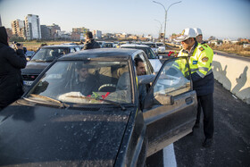 اهدا گل و شیرینی به رهگذران توسط پرسنل پلیس راهور در آیین افتتاحیه  پل امام علی(ع)