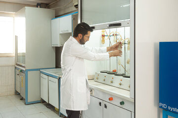 کارشناس آزمایشگاه در حال بررسی نمونه‌ها در بخش کنترل کیفیت کارخانه.